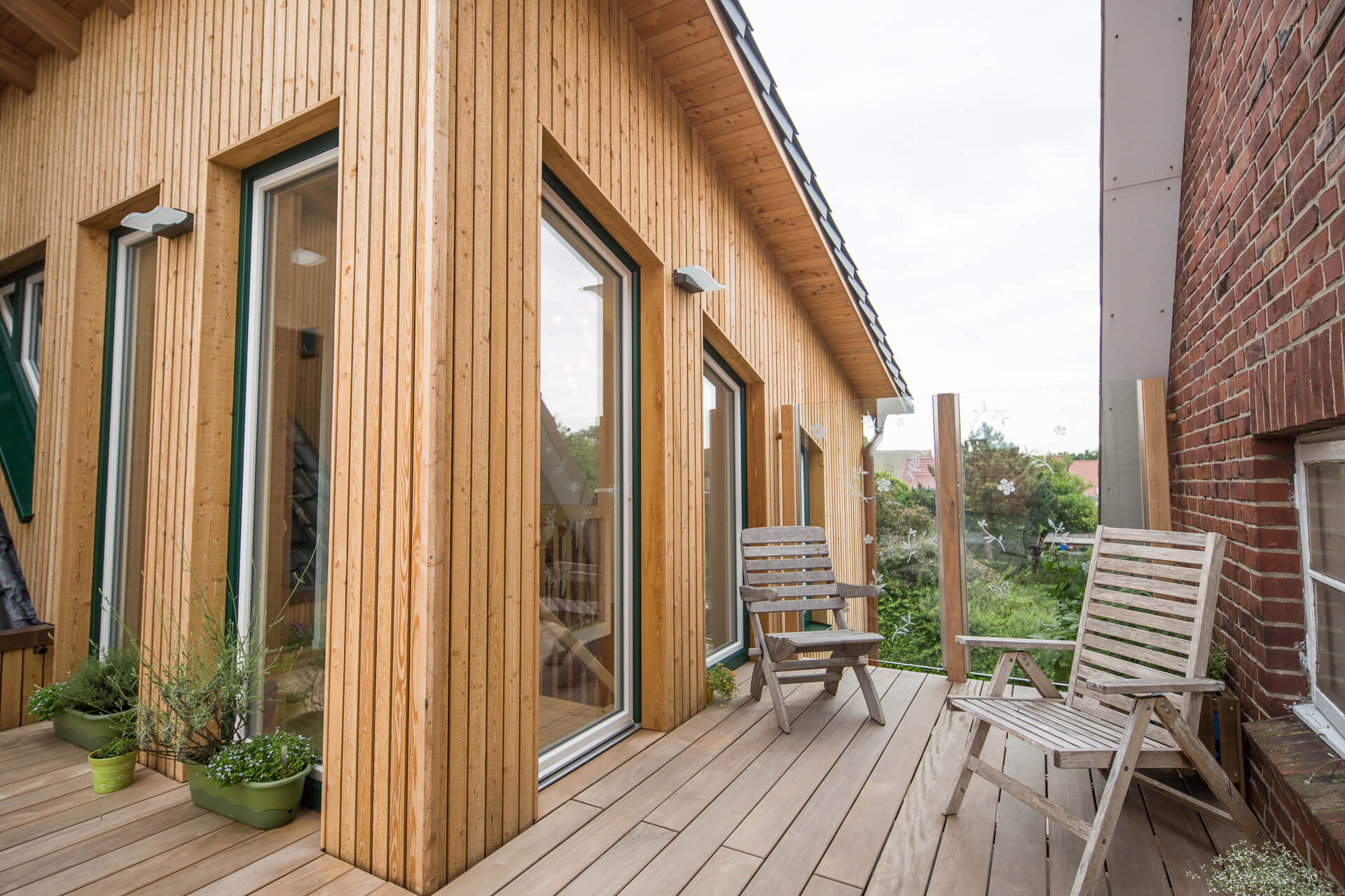 Foto Ryan Baugestaltung Anbau Francop Hallendach Terrasse an modernem Holzanbau aus Lerchenholz